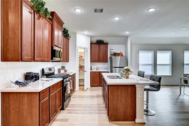 a bedroom with a bed chandelier and a window