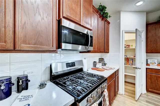 a bedroom with a large bed chandelier and a window