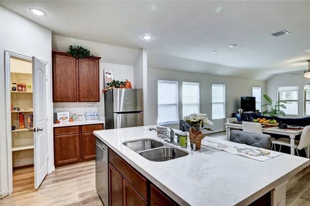 a bathroom with a sink mirror and shower