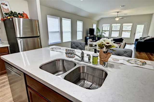 a spacious bathroom with a glass shower door and a window