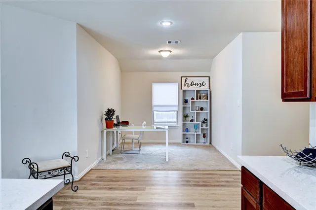 a en suite bathroom with a granite countertop sink and a mirror