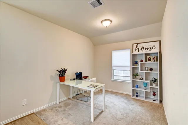 a bedroom with a bed next to a window and a chandelier