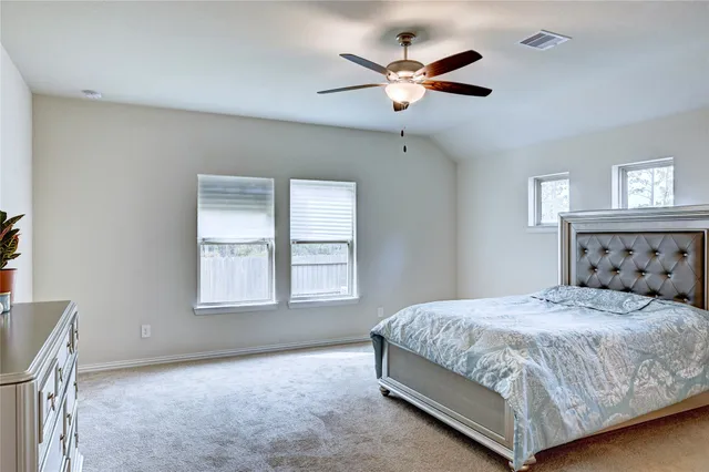 a view of a backyard with a tree and wooden fence