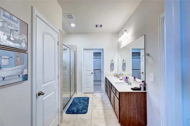 a living room with stainless steel appliances furniture and wooden floor