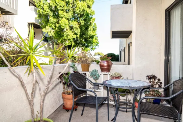 a backyard of a house with table and chairs