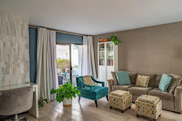 a living room with furniture and a large window