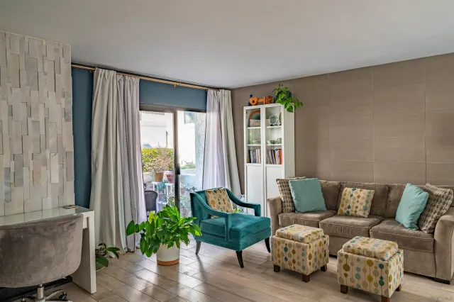 a living room with furniture and a large window