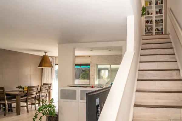 a view of entryway and hall with wooden floor