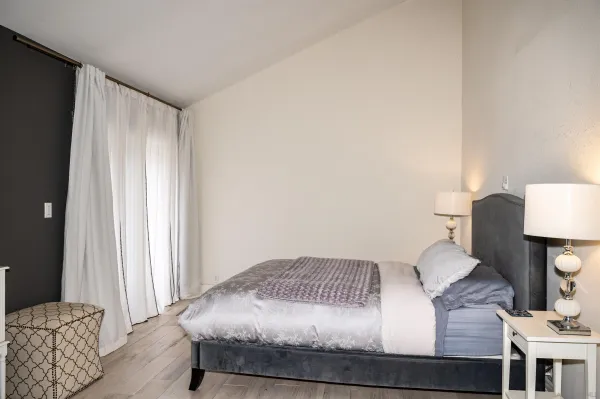 a bedroom with a bed and a lamp