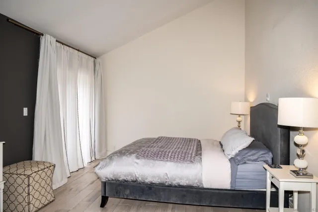 a bedroom with a bed and a lamp