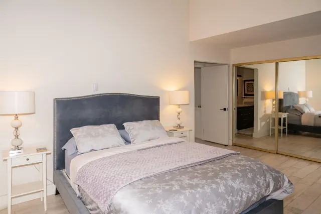 a bedroom with a bed and a lamp