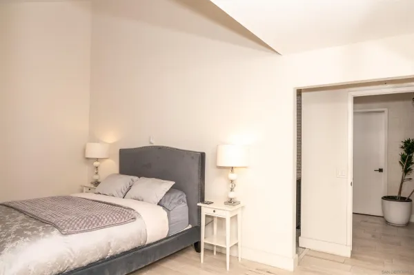 a bedroom with a bed and a table