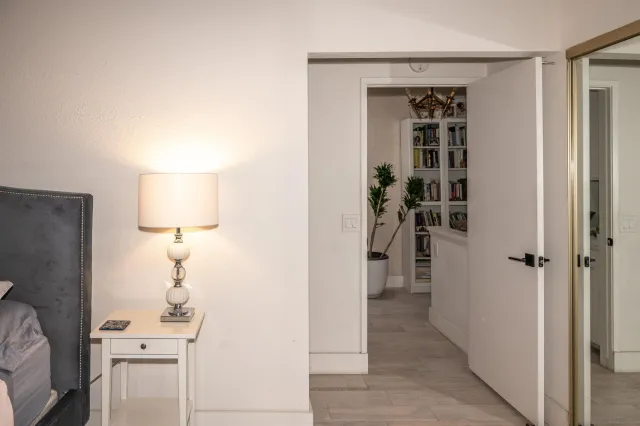 a view of a livingroom with wooden floor and a hallway