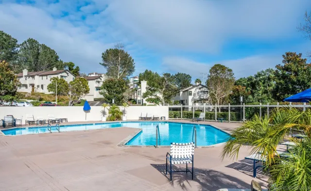 a view of outdoor space with swimming pool and trees