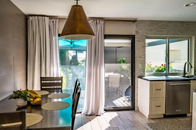 a dining room with furniture and a potted plant
