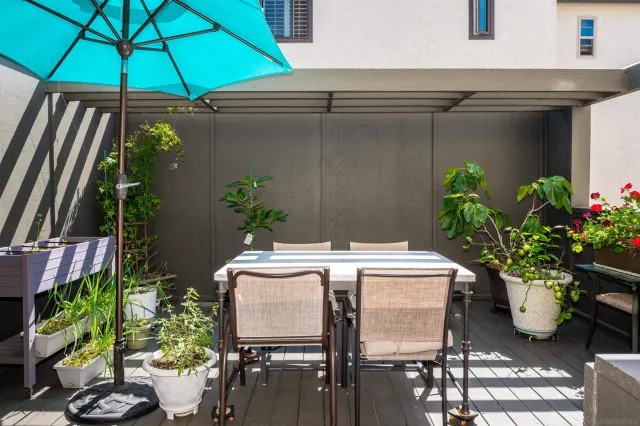 a table and chairs under an umbrella