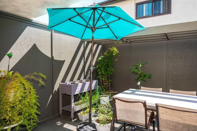 a table and chairs under an umbrella