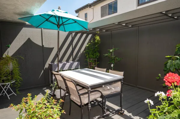 a table and chairs in patio of the house