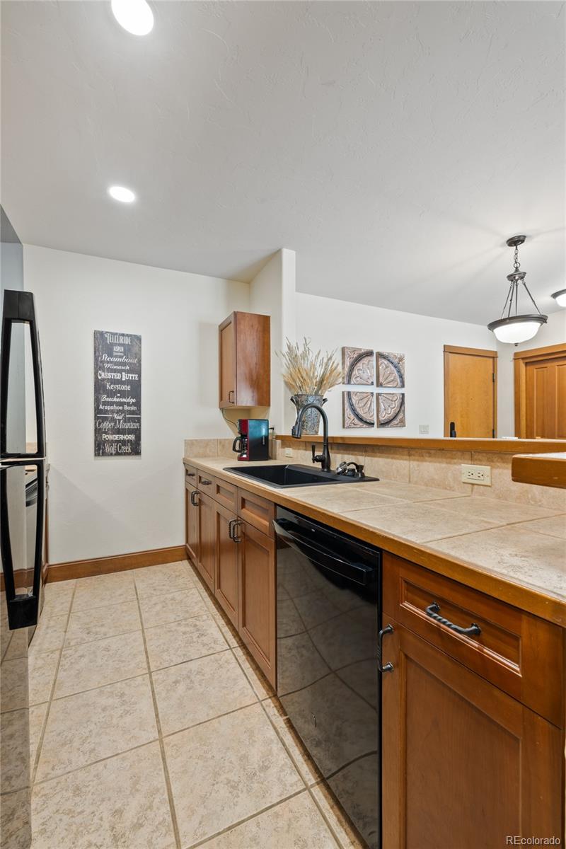 22787 Highway 6, Unit 209 Dillon, CO 80435 - Photo 11 of 49 a kitchen with a sink refrigerator and cabinets