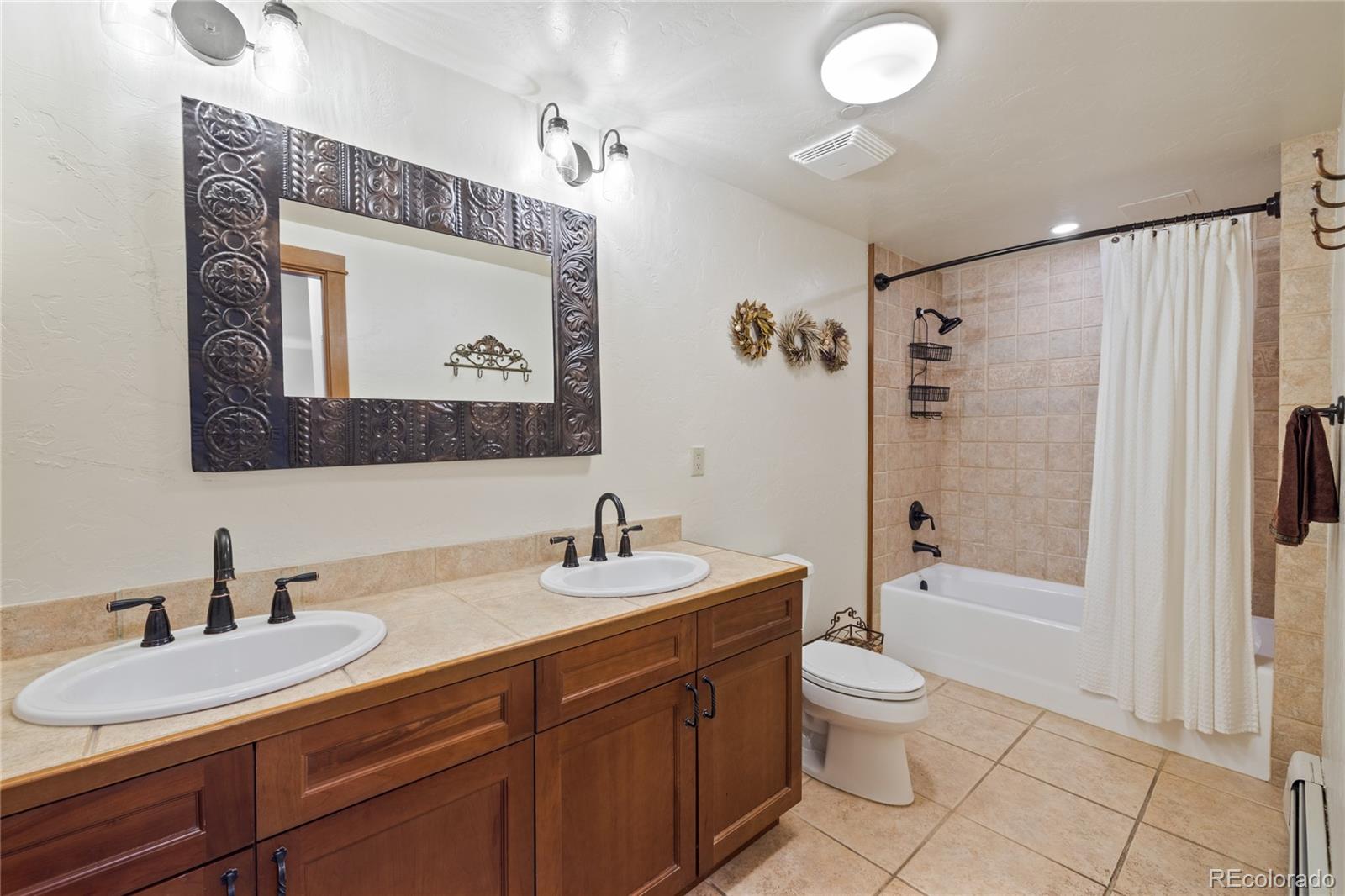 22787 Highway 6, Unit 209 Dillon, CO 80435 - Photo 14 of 49 a bathroom with a toilet a sink and shower