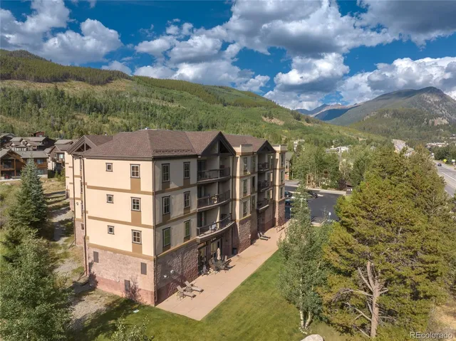a view of a town with large trees and a mountain view