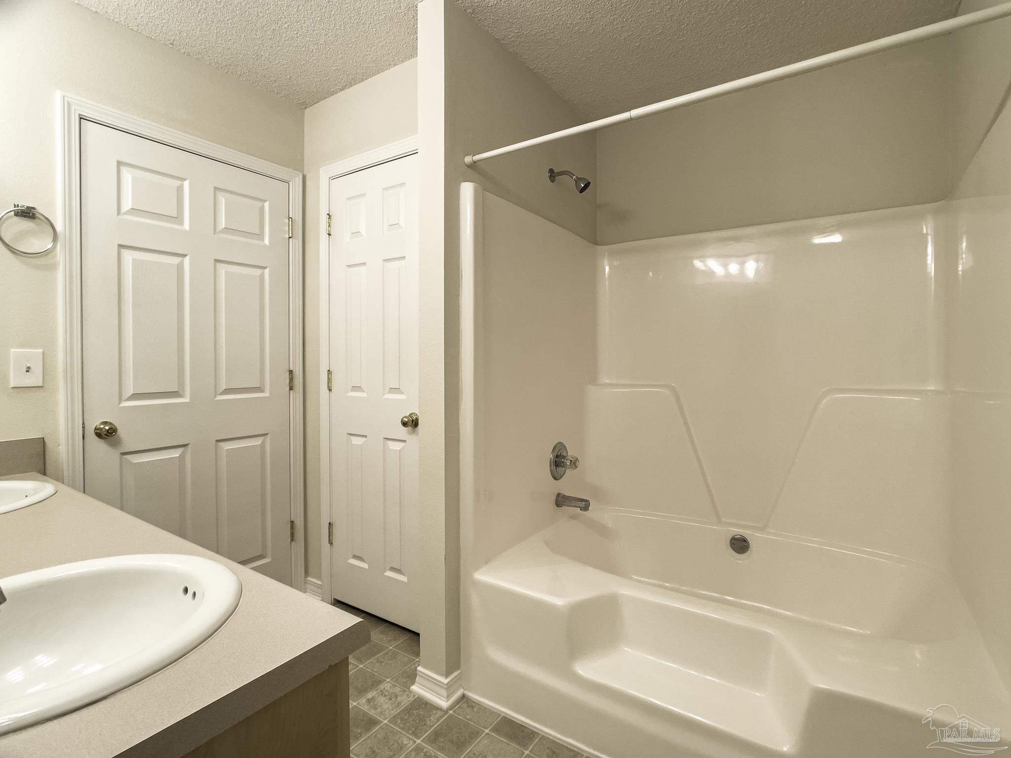 1267 Sterling Point Place Gulf Breeze, FL 32563 - Photo 15 of 27 a bathroom with a bathtub and a shower