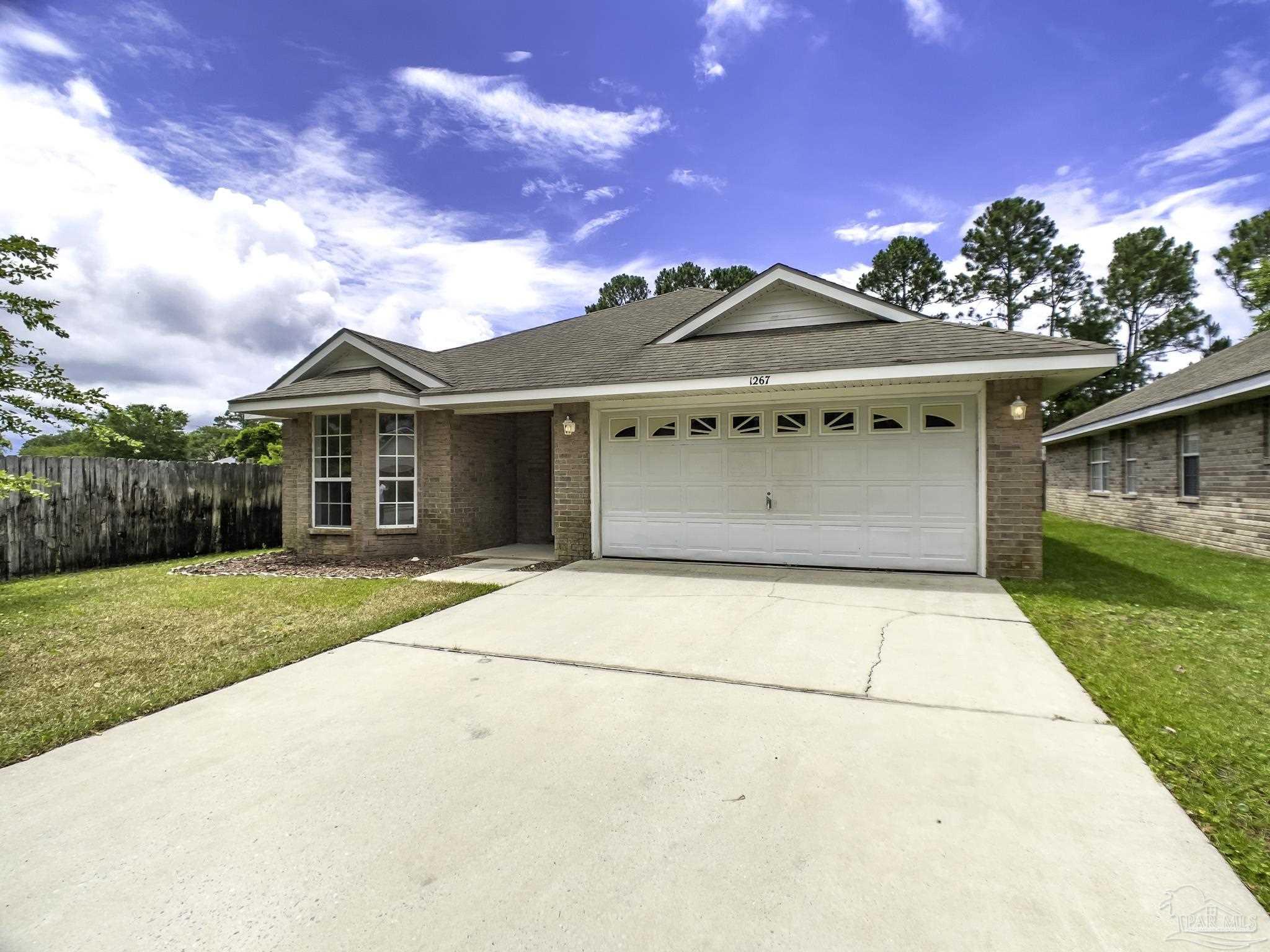 1267 Sterling Point Place Gulf Breeze, FL 32563 - Photo 2 of 27 a front view of a house with a yard