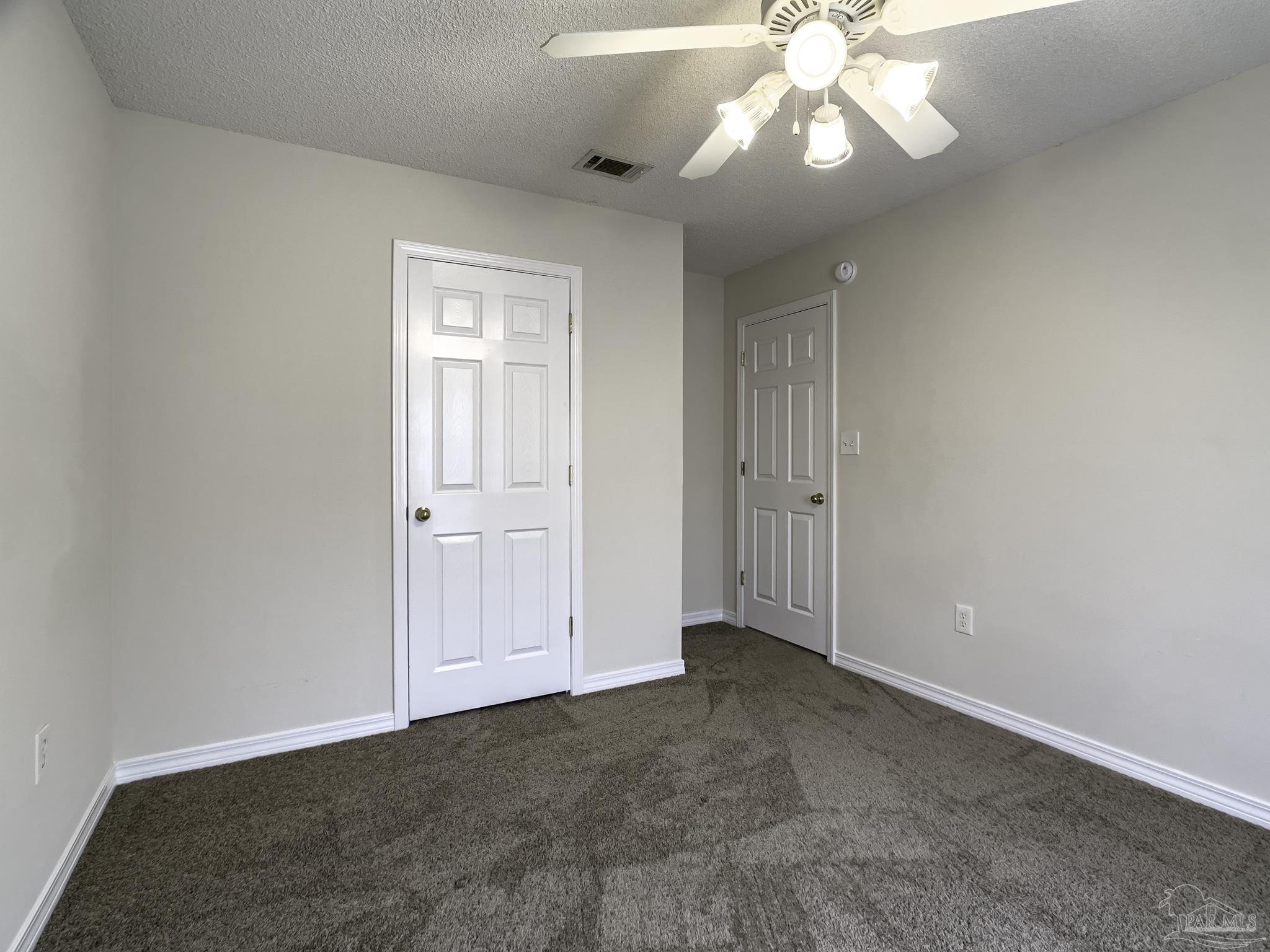 1267 Sterling Point Place Gulf Breeze, FL 32563 - Photo 23 of 27 an empty room with a chandelier fan and windows