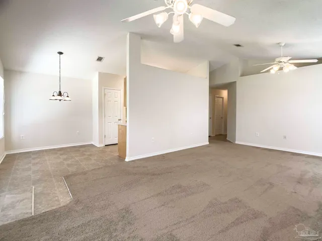 a view of empty room with a ceiling fan