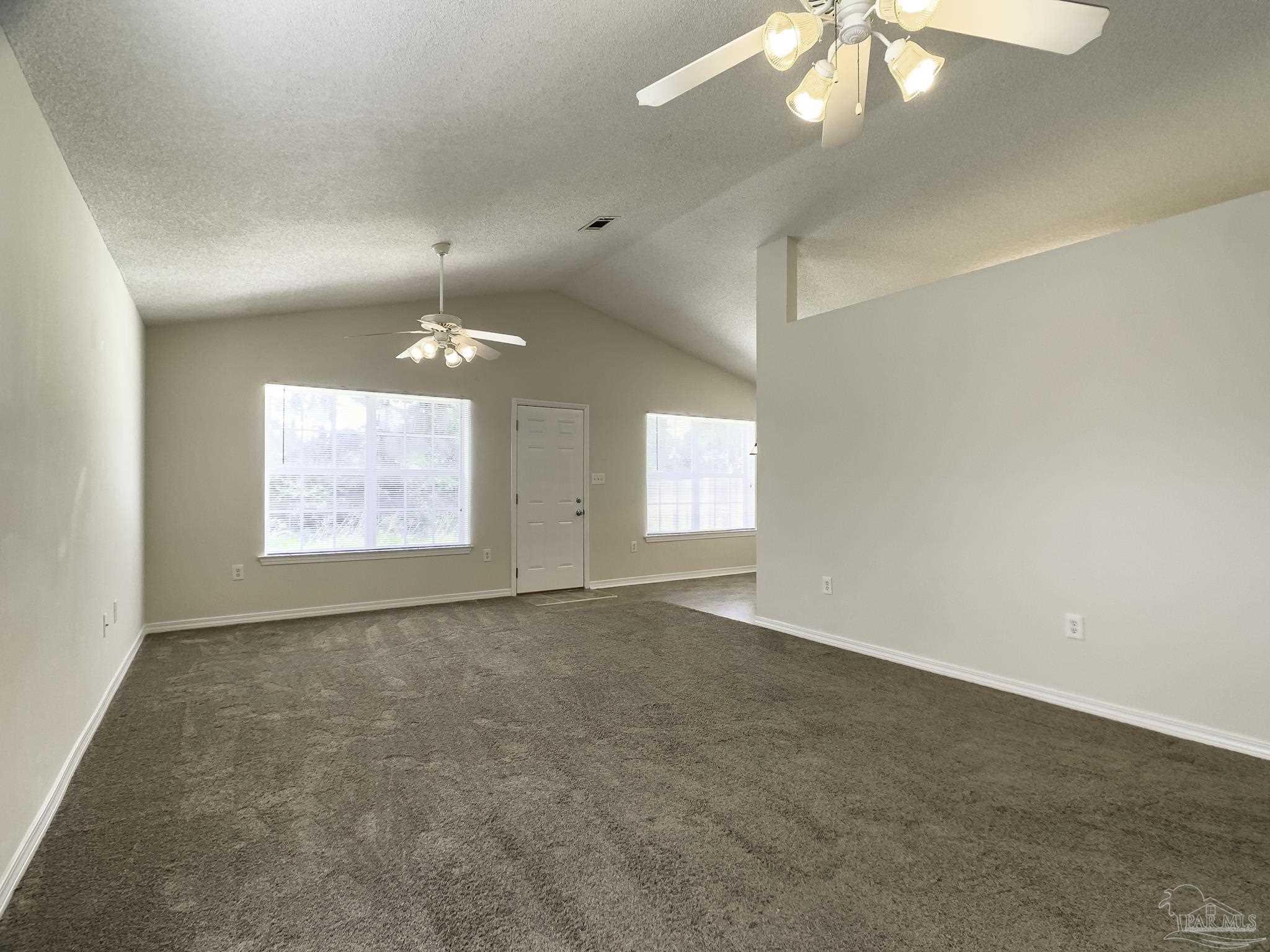 1267 Sterling Point Place Gulf Breeze, FL 32563 - Photo 4 of 27 en empty room with windows and fan