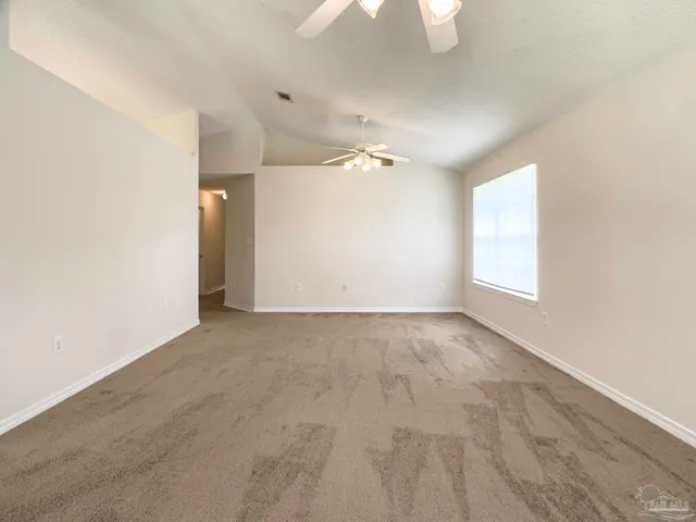 an empty room with windows and entrance