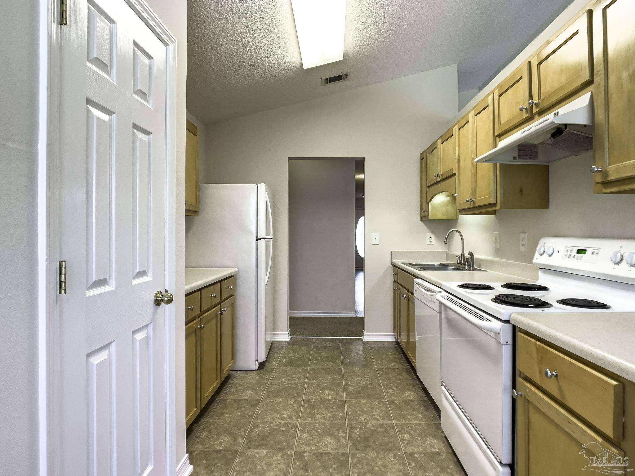 1267 Sterling Point Place Gulf Breeze, FL 32563 - Photo 7 of 27 a kitchen with a stove top oven sink and refrigerator
