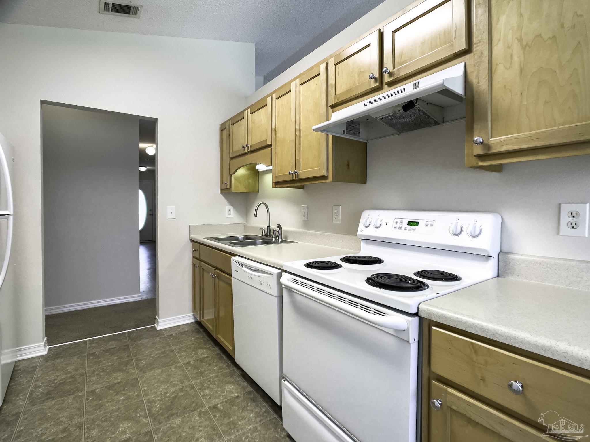 1267 Sterling Point Place Gulf Breeze, FL 32563 - Photo 8 of 27 a kitchen that has a stove and a microwave