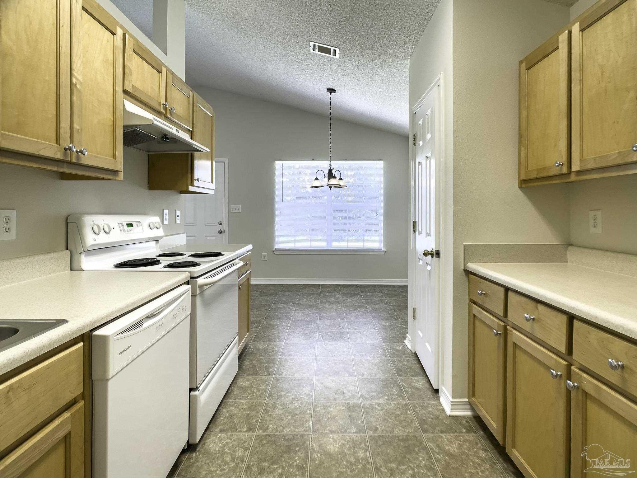 1267 Sterling Point Place Gulf Breeze, FL 32563 - Photo 9 of 27 a kitchen with granite countertop a sink stove and cabinets