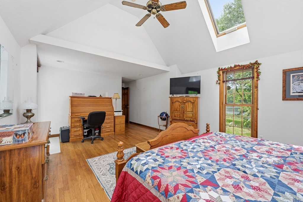 43 Flint Road Tyngsborough, MA 01879 - Photo 14 of 40 a bedroom with a bed and a chandelier