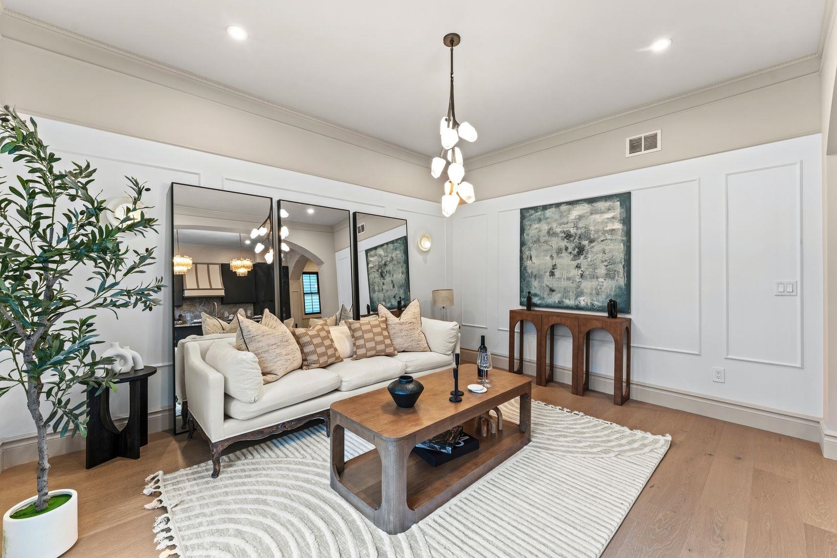 83 Liberty Place, Unit 1 Weehawken, NJ 07086 - Photo 11 of 39 a living room with furniture and a chandelier