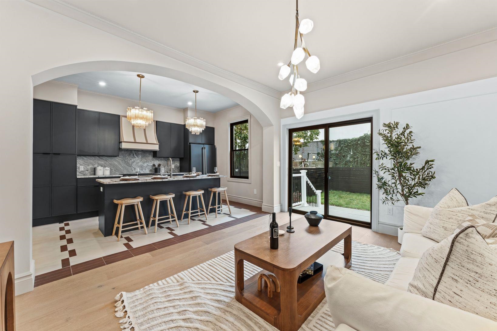 83 Liberty Place, Unit 1 Weehawken, NJ 07086 - Photo 13 of 39 a living room with furniture a flat screen tv and a large window