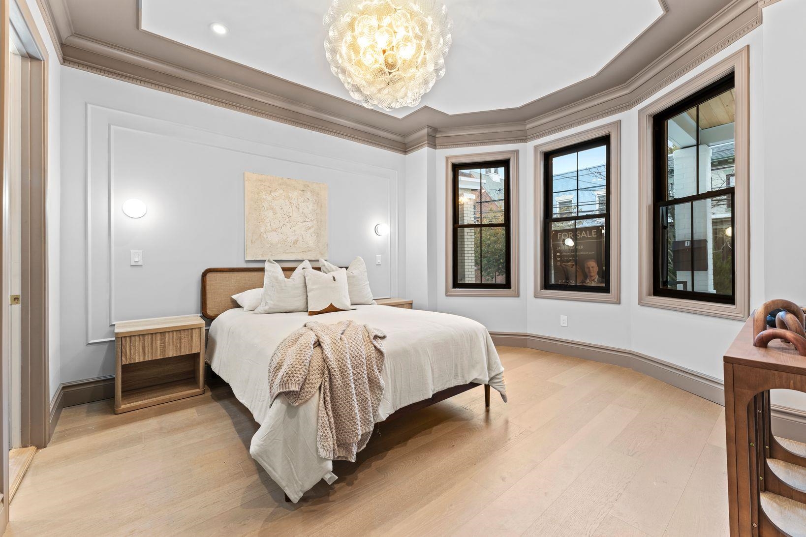 83 Liberty Place, Unit 1 Weehawken, NJ 07086 - Photo 16 of 39 a spacious bedroom with a bed and a large window