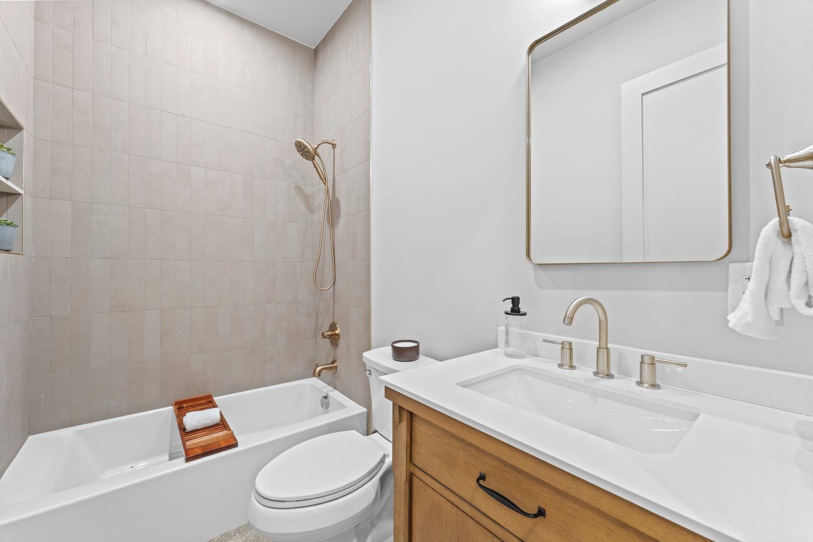 83 Liberty Place, Unit 1 Weehawken, NJ 07086 - Photo 23 of 39 a bathroom with a granite countertop toilet a sink and a mirror