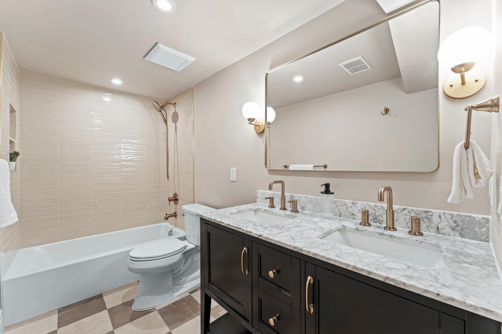 83 Liberty Place, Unit 1 Weehawken, NJ 07086 - Photo 29 of 39 a bathroom with a granite countertop sink a toilet and a large mirror