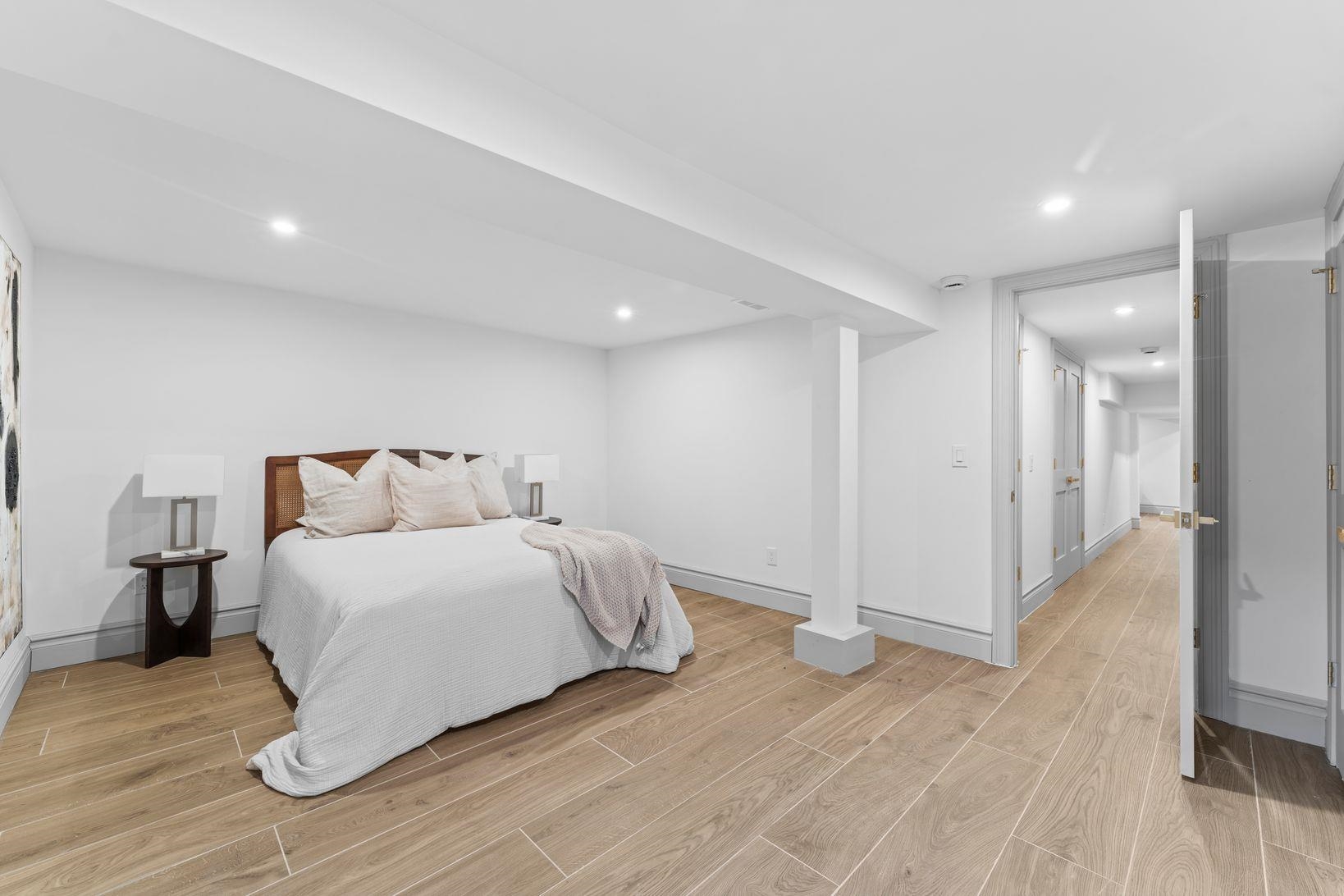 83 Liberty Place, Unit 1 Weehawken, NJ 07086 - Photo 30 of 39 a spacious bedroom with a bed and wooden floor