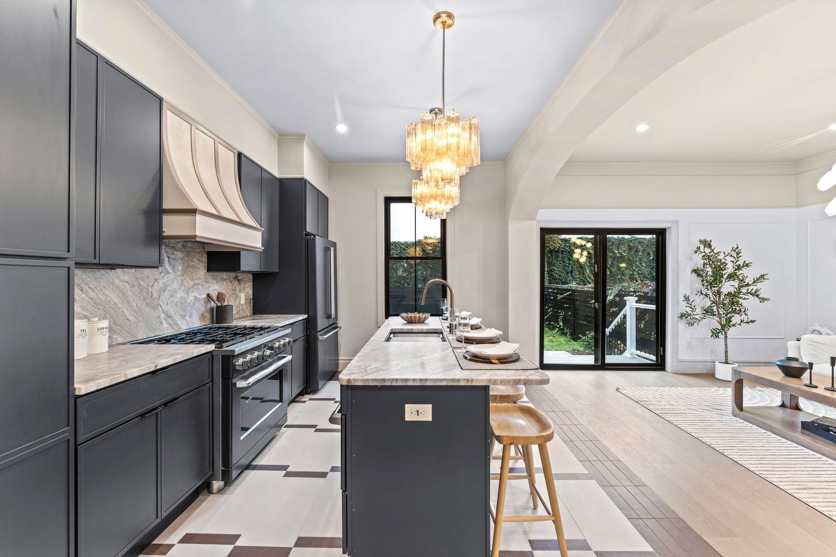 83 Liberty Place, Unit 1 Weehawken, NJ 07086 - Photo 3 of 39 a large kitchen with stainless steel appliances granite countertop a stove a sink dishwasher and a refrigerator with wooden floor