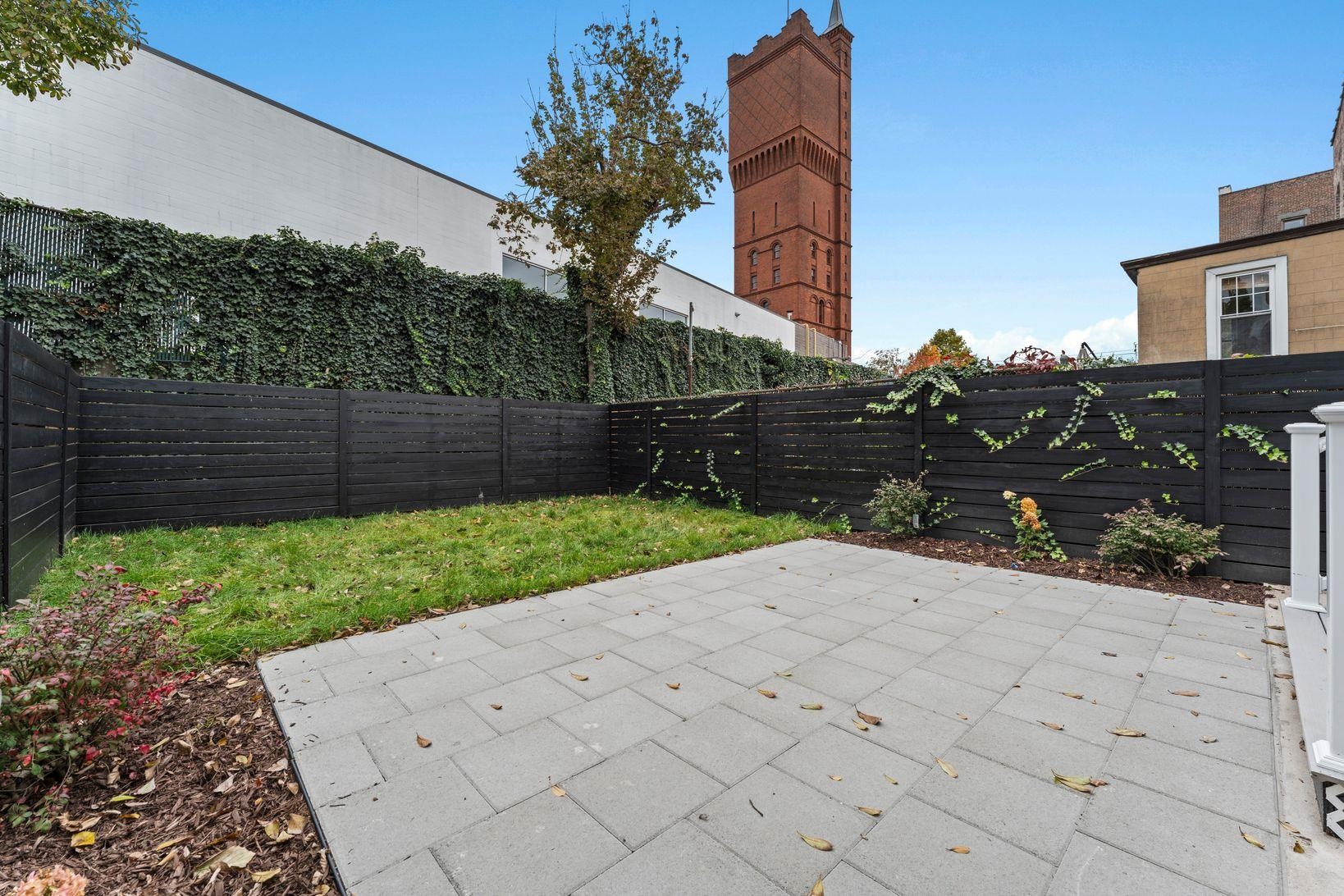 83 Liberty Place, Unit 1 Weehawken, NJ 07086 - Photo 32 of 39 a backyard of a house with lots of green space