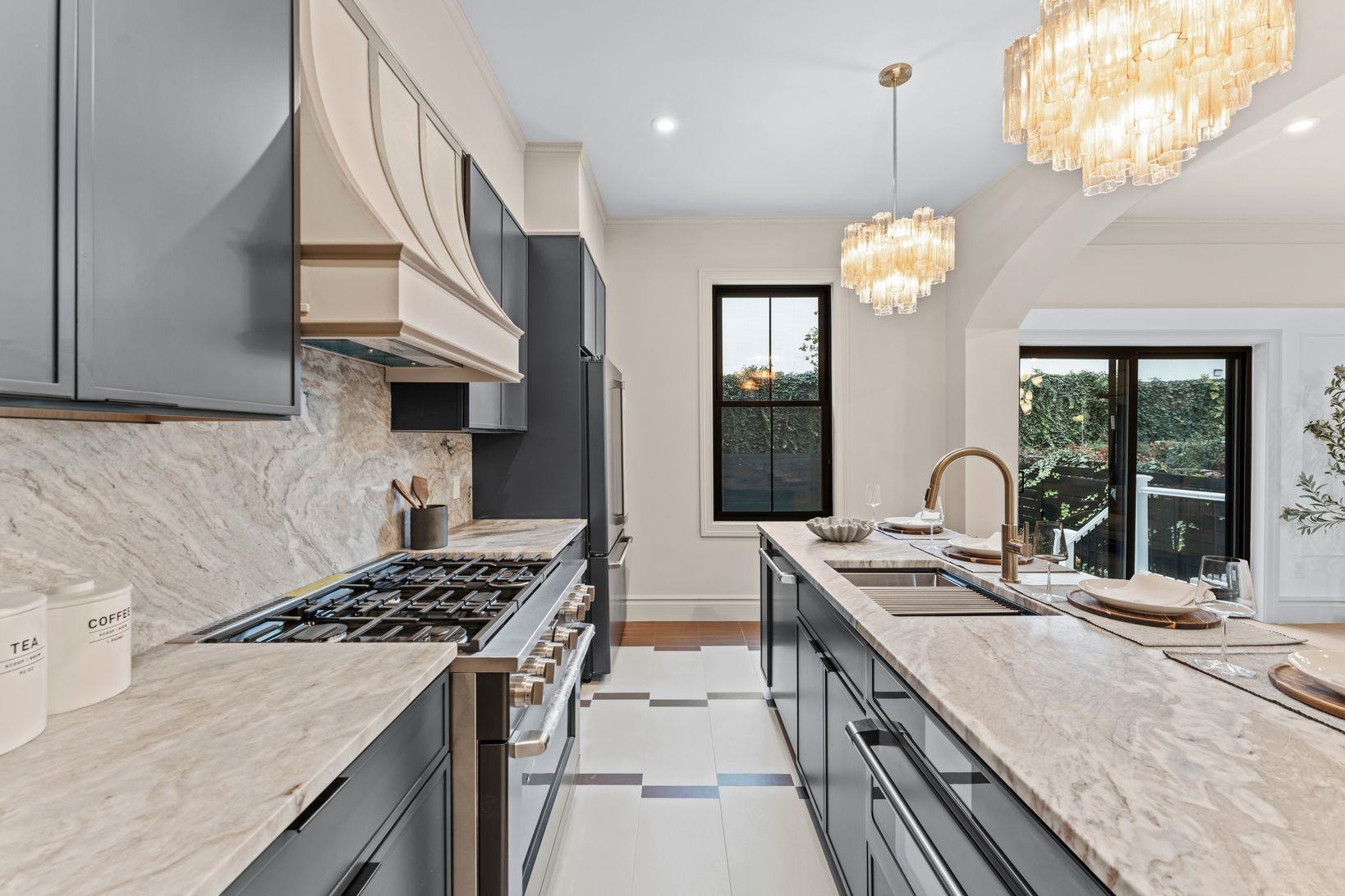 83 Liberty Place, Unit 1 Weehawken, NJ 07086 - Photo 7 of 39 a kitchen with stainless steel appliances granite countertop a stove a sink dishwasher and a refrigerator with wooden floor