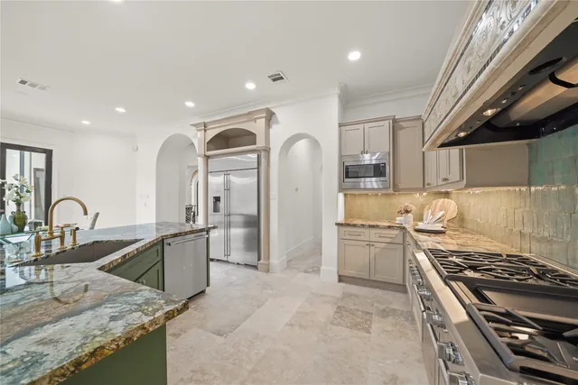 a spacious bedroom with a bed a couch and a window