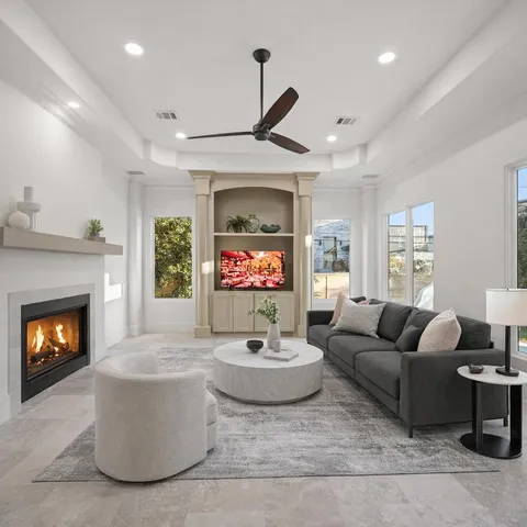 a living room with furniture a rug and a table