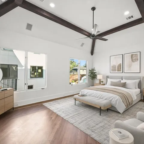 a bedroom with a large bed and a chandelier