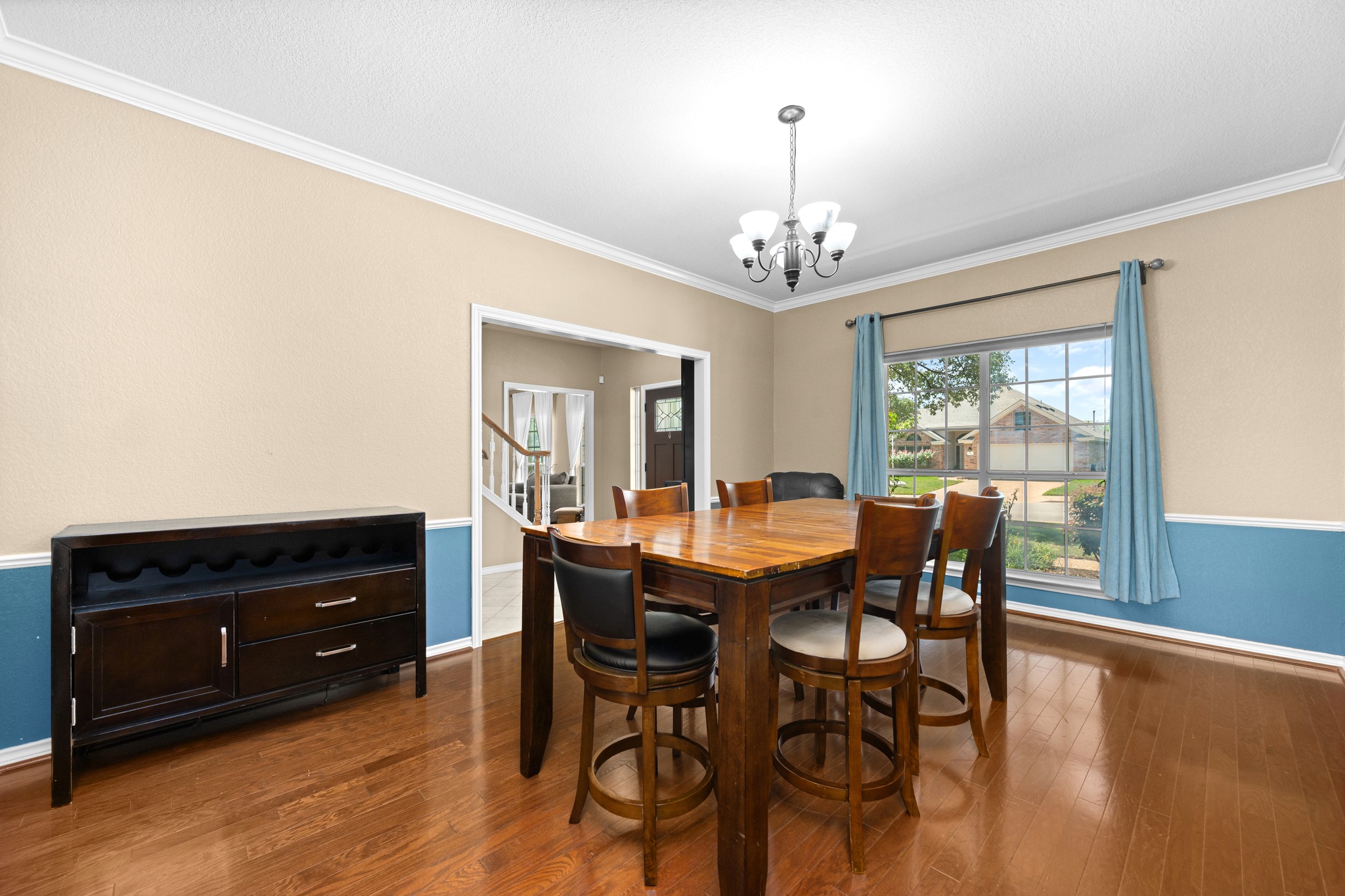 108 Thornwood Road Georgetown, TX 78628 - Photo 6 of 40 Natural light illuminates the rich hardwood flooring and elegant crown molding in this inviting dining space.