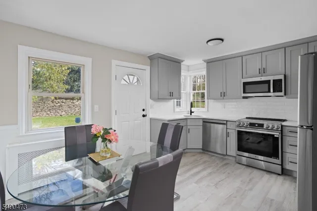 a kitchen with a table chairs stove and microwave