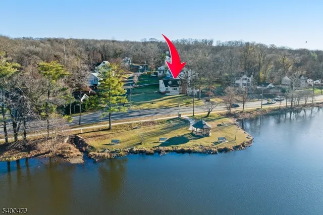 a view of a swimming pool with an outdoor seating and lake view